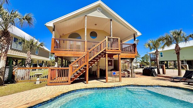 A two-story building with a balcony and a pool.
