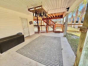 Relax under a charming pergola, surrounded by lush greenery and a cozy seating area.