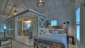 A spacious bedroom with a large bed, a wooden headboard, and a walk-in closet. - Memory Maker, Top of GA Cottage in charming Mineral Bluff with AC, WiFi (Mineral Bluff)