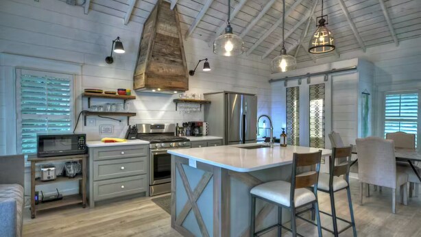 A spacious kitchen with a large island, stainless steel appliances, and pendant lighting. - Memory Maker, Top of GA Cottage in charming Mineral Bluff with AC, WiFi (Mineral Bluff)