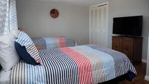 A bedroom with a bed, a television, and a wardrobe. - Spacious Vermilion House on the Lake (Vermilion)