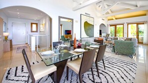 A modern dining area with a glass table, chairs, and a patterned rug. - Magnificent sea view villa - DG (Cap-d'Ail)
