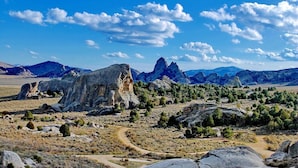 A rugged landscape with prominent rock formations and a clear sky.