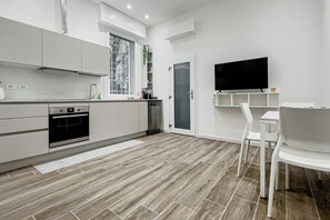 Enjoy meals in the kitchen with an oven and dining area featuring a table and chairs.