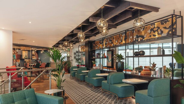 A modern interior with seating, tables, and decorative elements. - Hotel Indigo London Clerkenwell by IHG (London)
