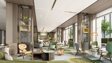 A modern hotel lobby with a mix of seating areas, a bar, and large windows offering views of greenery.