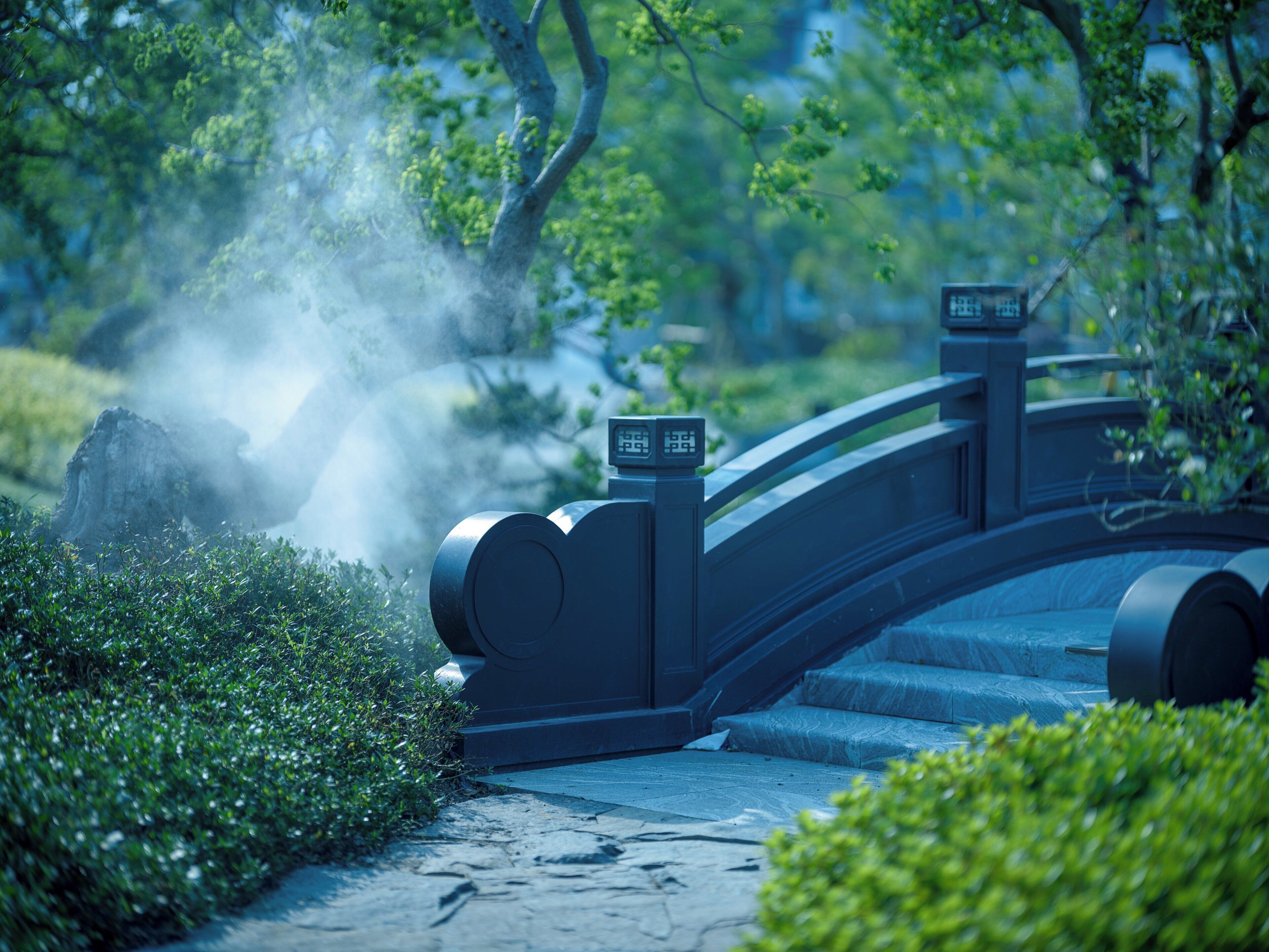 A stone bridge with a digital display, surrounded by greenery and mist.