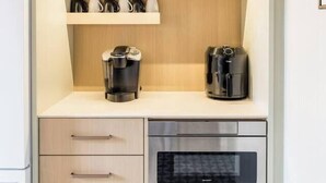 A compact kitchenette with a coffee maker, a toaster, and a microwave. - Sandy Cove 04 Tucker Inn (Happy Adventure)