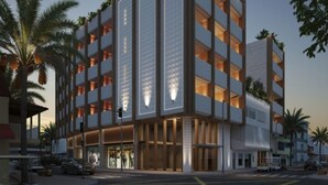 A multi-story hotel with a modern design, featuring balconies on each floor, a ground-level entrance, and a crosswalk in front. - Zapadilly Tree Hotel (San Andres)