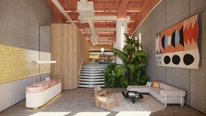 A modern lobby with a reception desk, seating area, staircase, and a large abstract painting. - Zapadilly Tree Hotel (San Andres)