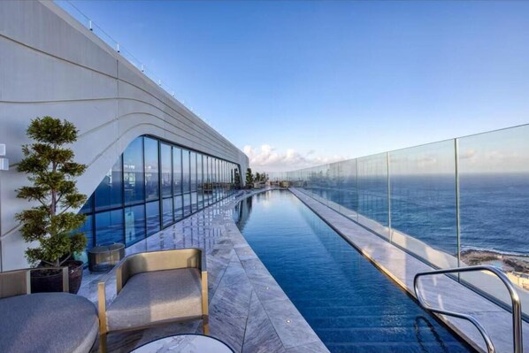 Outdoor pool, open 10:00 AM to 5:00 PM, pool umbrellas, sun loungers