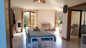 A spacious dining area with a long table, chairs, and a buffet table.