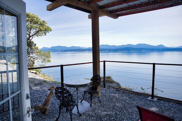 Covered patio with Bbq, fire table and dining table. Remote patio lights.
