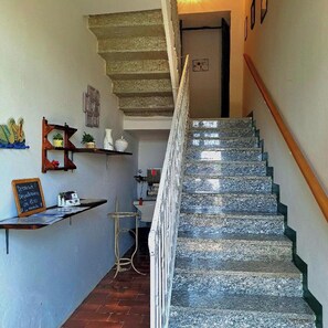 Stairs lead to an upper floor with a door at the top.