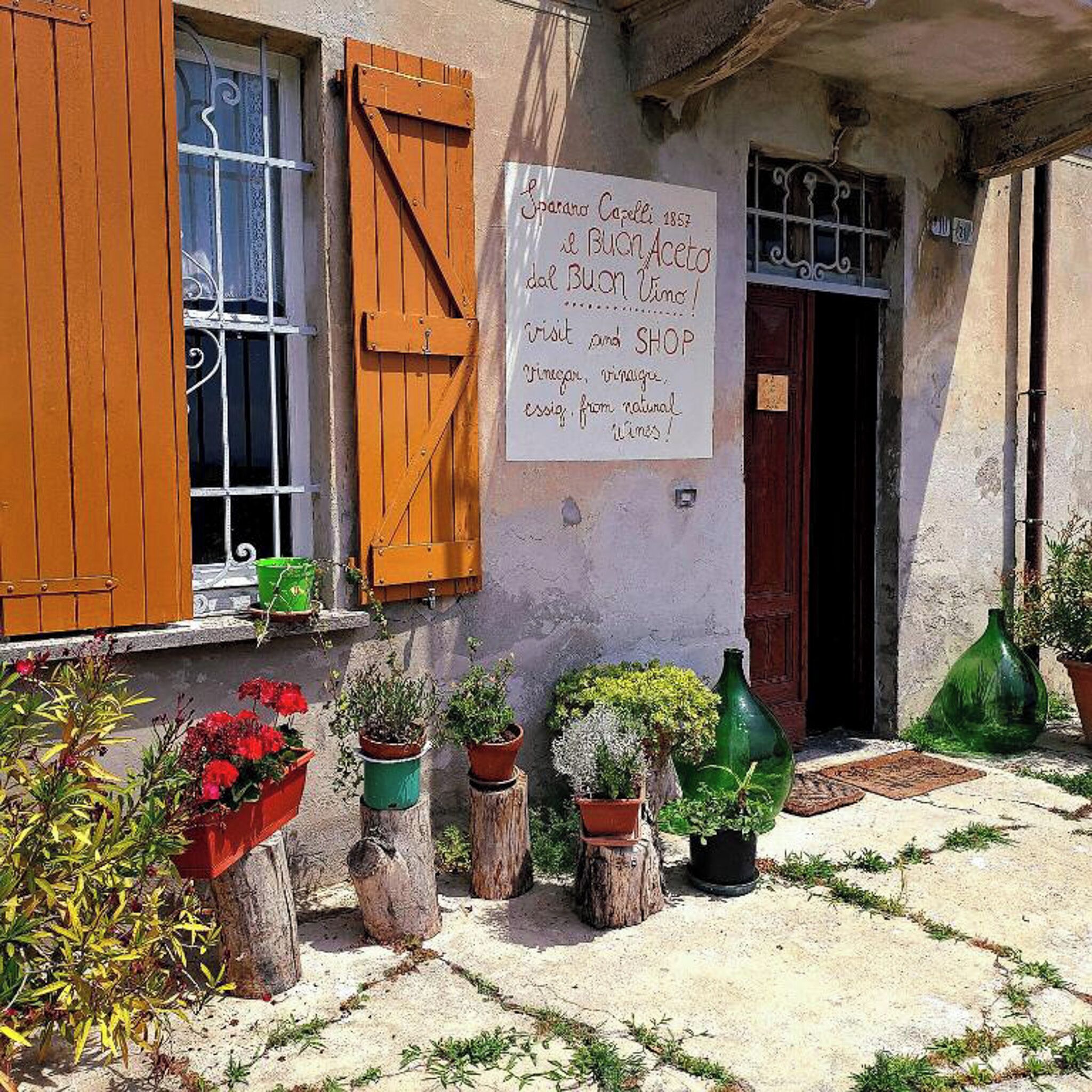 A building with a signboard advertising a wine shop and restaurant.