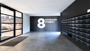 A hallway with a large number '8' sign and a row of mailboxes on the right.