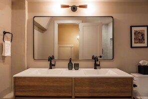 A bathroom with a double sink, wooden cabinet, and a large mirror. - The Artisan's Duplex - 8Bd/5.5Bth w/2 Car Parking! (Philadelphia)
