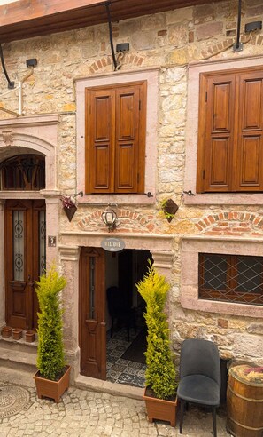 Experience the charm of Hera Pansiyon, a traditional Turkish guesthouse with a welcoming atmosphere and inviting entrance.