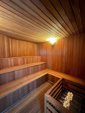 A sauna with wooden benches and a sloped ceiling. - Get a Flat 1302 Bienal Ibira SP (Sao Paulo)