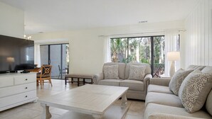 A spacious living area with a sofa set, a coffee table, and a flat-screen TV. - Sleeps 8!  2 Mins to Beach, 3 BD 3.5 BR- Sea Pines (Hilton Head Island)