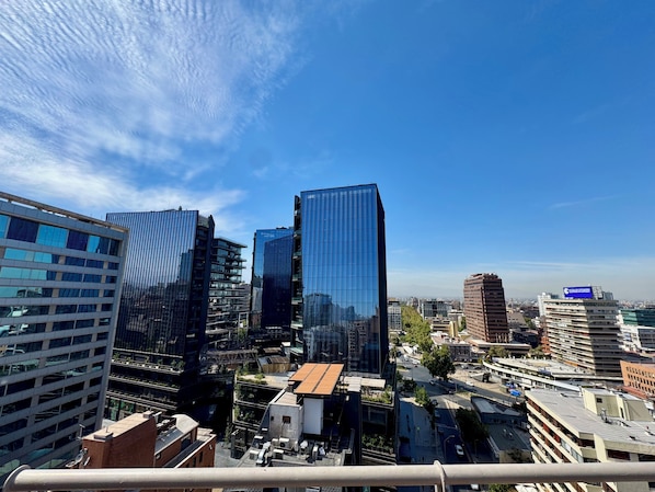 A cityscape with modern high-rise buildings, a clear sky, and a view of the urban environment.