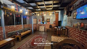 A cozy retreat with brick walls, wooden benches, and a traditional rug.