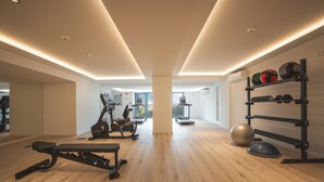 A modern gym with exercise equipment, a weight rack, and a large exercise ball. - Babi by the Sea by Atlantic Holiday (Funchal)