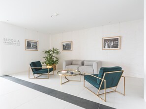 A modern living room with a sofa, two armchairs, a coffee table, and a potted plant. - Babi by the Sea by Atlantic Holiday (Funchal)