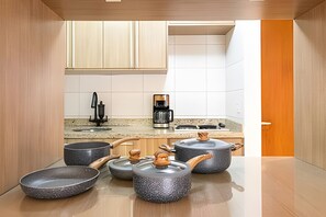 A modern kitchen with granite countertops, a coffee maker, and stoneware pots. - ARK Houses - Flat Standard Vista-Mar c/ Piscina na Cobertura (Santos)