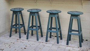 A kitchen with white cabinets, a window, and a wooden countertop. There are four blue stools. - 3-bedroom House with Heated Pool in Delightful St. Augustine. Pet-Friendly! (St. Augustine)