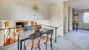 A dining area with a table, chairs, and a decorative wall piece. - 2 Mi to Citadel Mall: Home w/ Furnished Patio! (Colorado Springs)