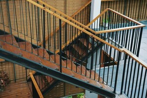 A multi-level wooden staircase with metal railings. - Baoxingtian Sister Inn (Baoxing)