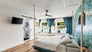 A bedroom with a bed, a ceiling fan, a TV, and a window with curtains. - Spacious 4-bedroom house with AC, WiFi, Houston Hideaway 10 min to NRG (Houston)