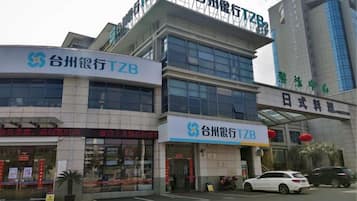 A commercial building with signage for Tzuan Bank and a restaurant.