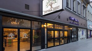 Fachada com uma placa indicando 'Oak Town Roast' e uma cafeteria chamada 'Botevar Coffee', com amplas janelas de vidro.