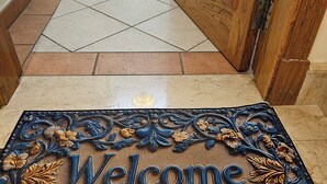 A welcome mat with floral patterns and the word "Welcome" in the center. - Country View Apartment (Mellieha)