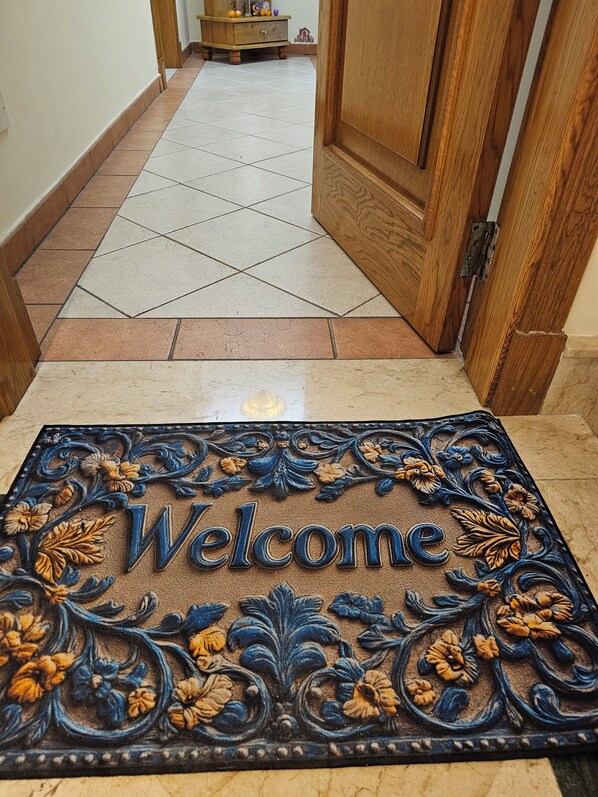 A welcome mat with floral patterns and the word "Welcome" in the center. - Country View Apartment (Mellieha)