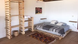 A room with a bed, a wooden ladder, a woven basket, and a thatched roof. - New ad (Zipolite)
