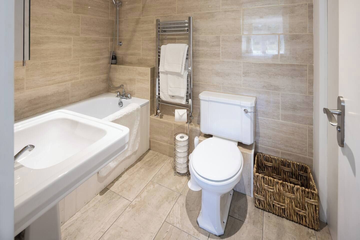 A bathroom with a bathtub, a toilet, and a shower.
