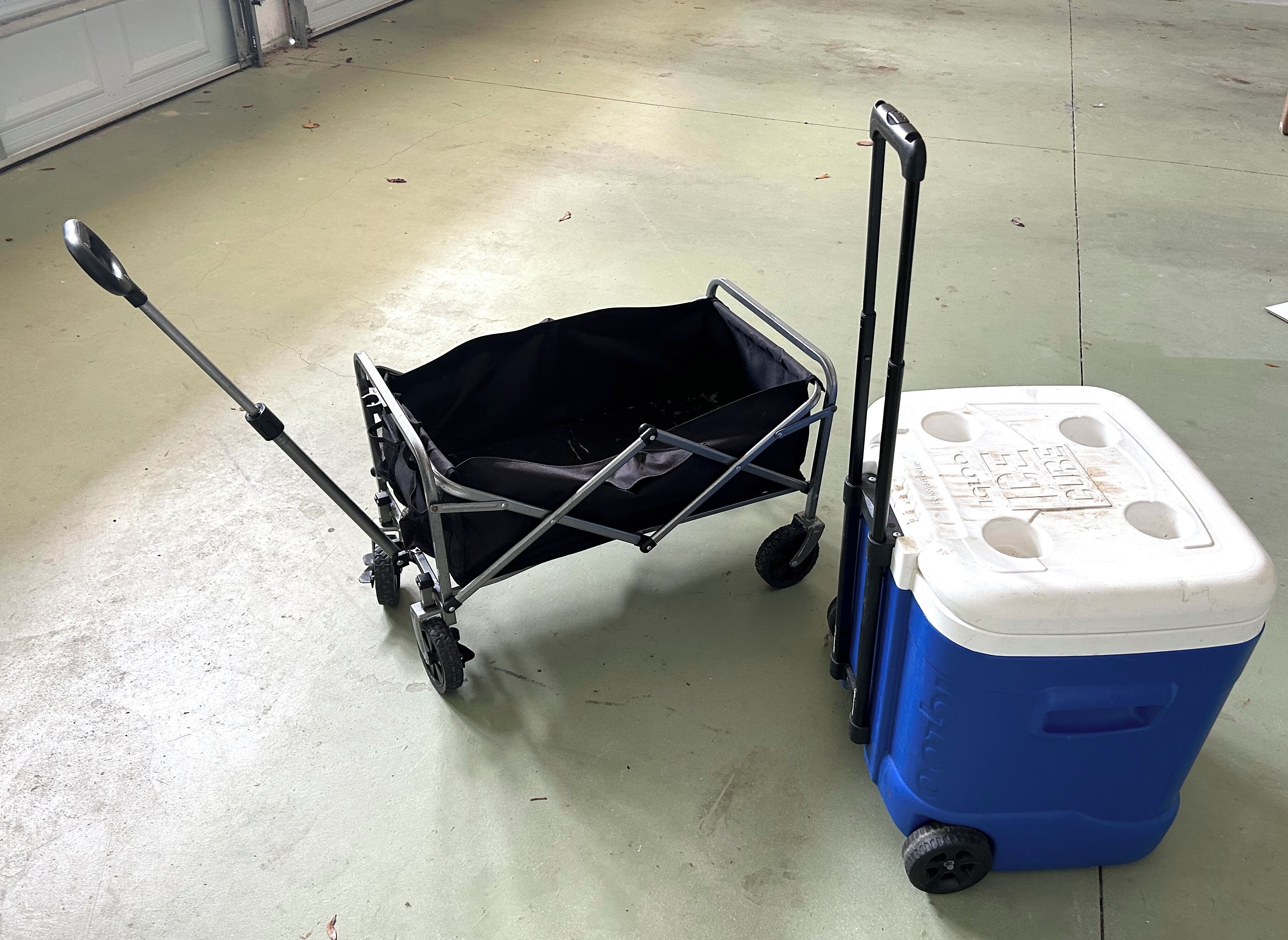 Un carrito con una cesta negra y un enfriador azul con tapa blanca.