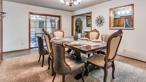 A dining room with a large table, six chairs, and a chandelier. - Spacious 5-bedroom house with AC, WiFi in phenomenal Oklahoma City (Oklahoma City)