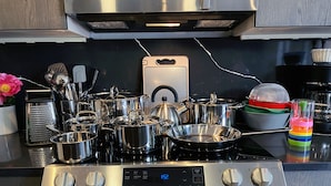 A kitchen with a stainless steel stove, oven, and various pots and pans. - Unit 2: Cozy 1-Bed in the heart of Dc (Washington)
