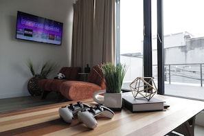 Relax in this stylish living room with a large window offering a view of the city.