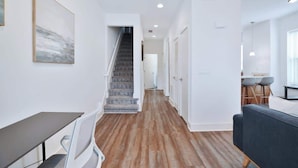 A modern interior with a staircase, a dining area, and a seating area. - Contemporary Vintage Home (Near Downtown!) (Columbus)