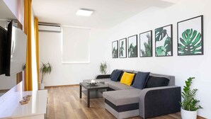 A modern living room with a sofa, coffee table, and artwork on the wall. - Holiday home mit Pool und Meerblick (Vela Luka)