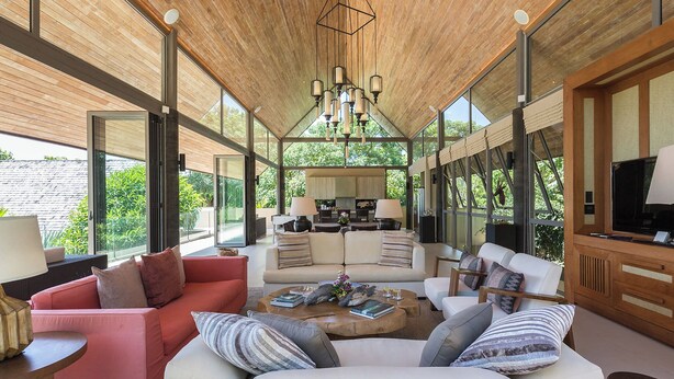 A spacious living area with a high ceiling, large windows, and a central seating arrangement. - Luxe Vacay Atulya Residence | Chef & Staff | LTH-1 (Koh Sumui)