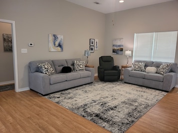 Spacious living area with new sofa, love seat and massaging recliner