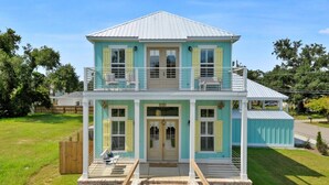 A two-story house with a balcony, a front porch, and a garage.