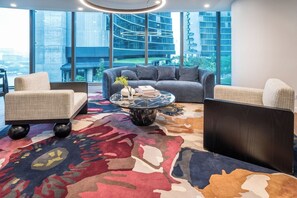 A modern lounge with a sofa, armchairs, and a coffee table.