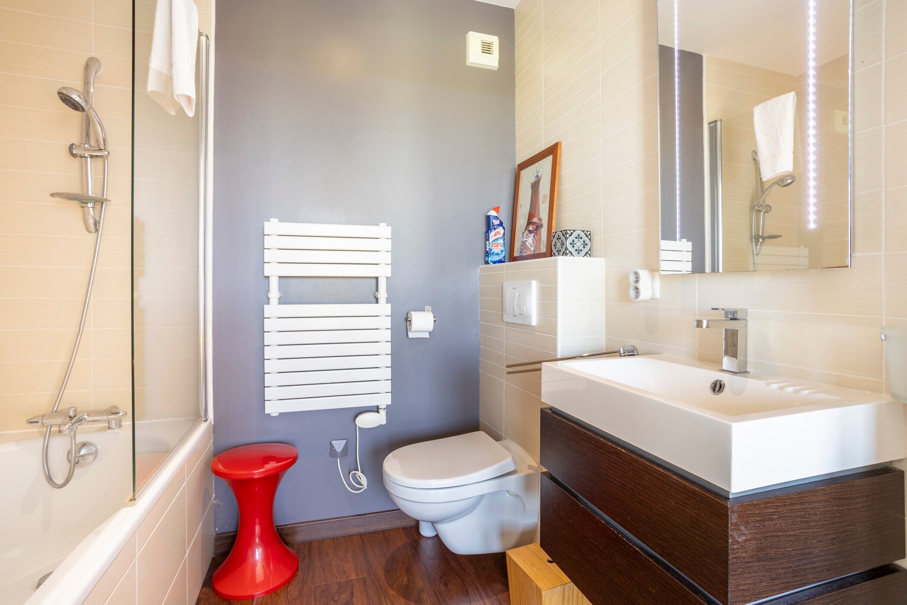 A modern bathroom with a bathtub, toilet, and sink.